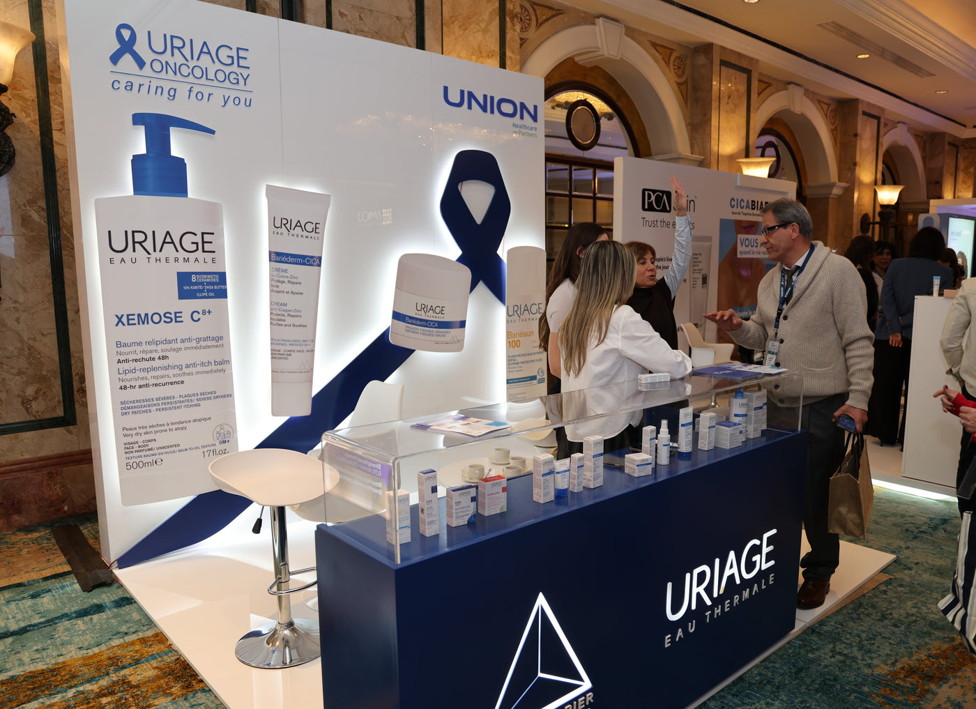 Uriage booth at a conference with people around