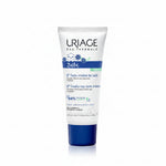A tube of Uriage Eau Thermale Bébé baby scalp care cream, featuring a white tube with blue and black text and graphics, and a dark blue cap, set against a plain white background.