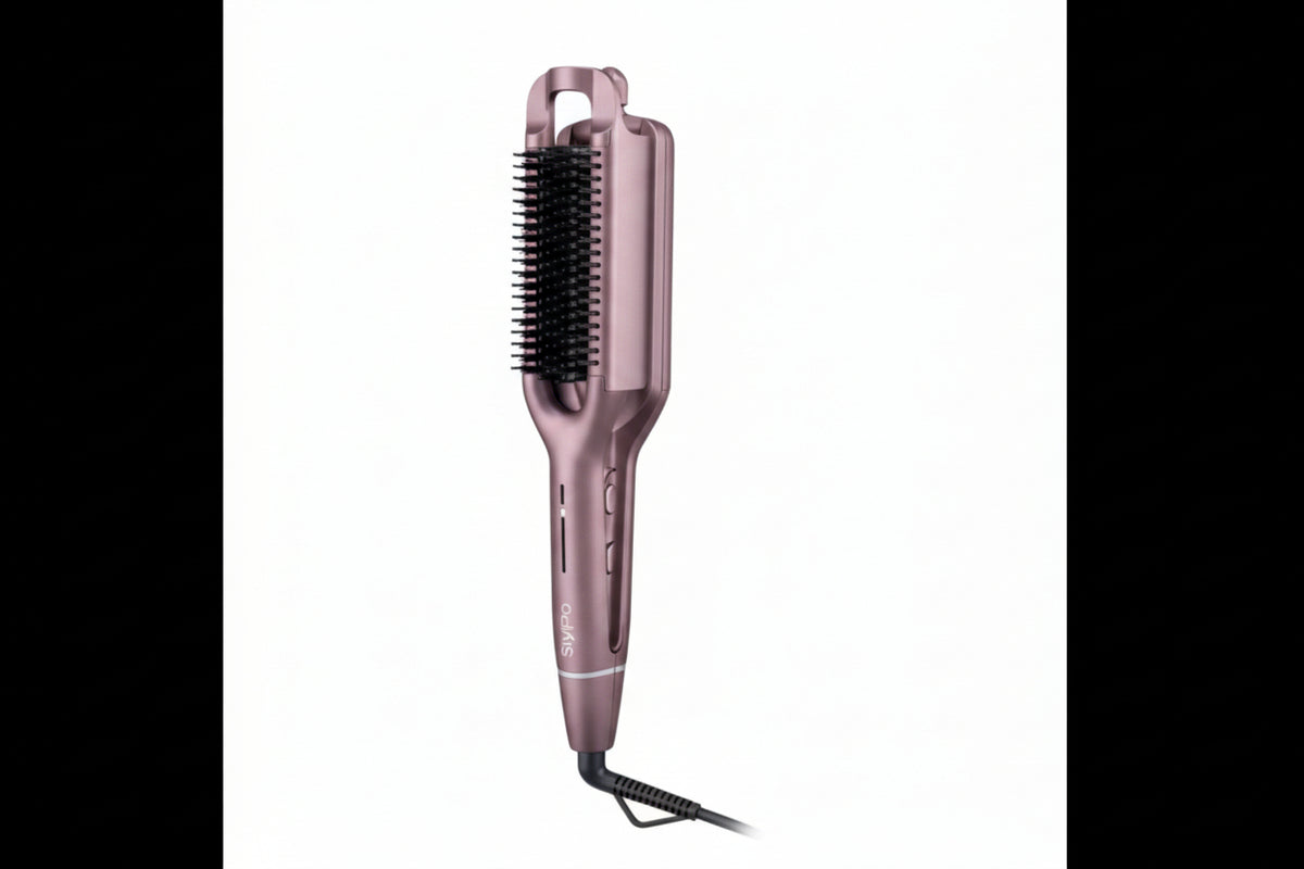 Rose gold hair straightener with bristle brush on a white background