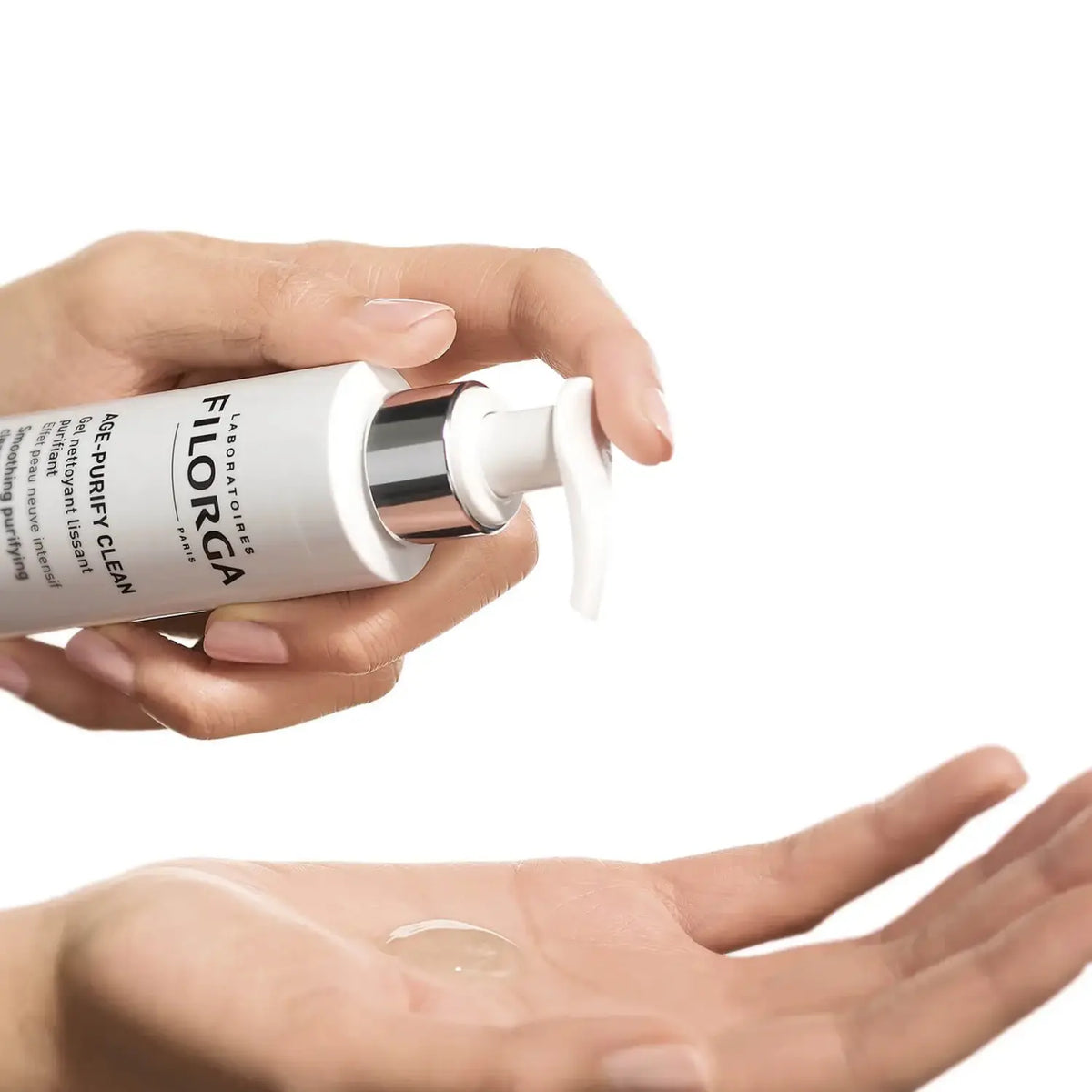 Hand holding a Filorga skincare product with a small amount on the palm