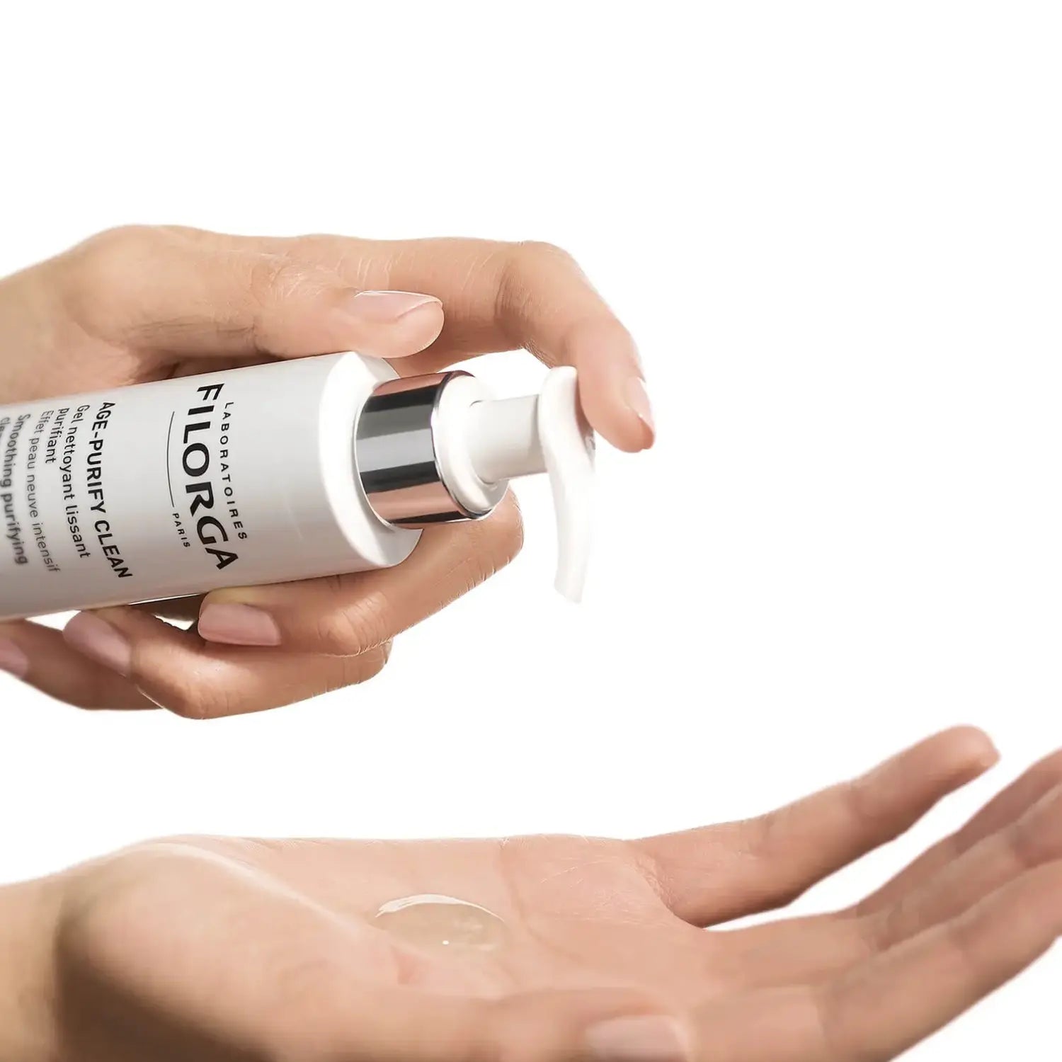Hand holding a Filorga skincare product with a small amount on the palm