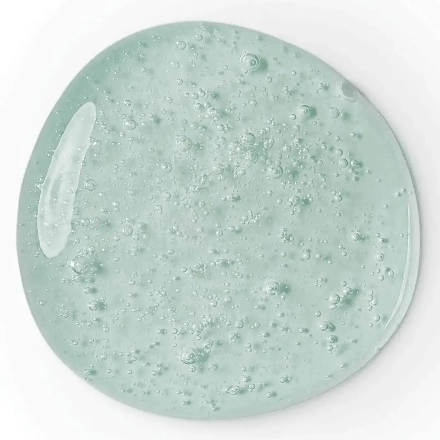 Close-up of a light green gel with bubbles on a white background