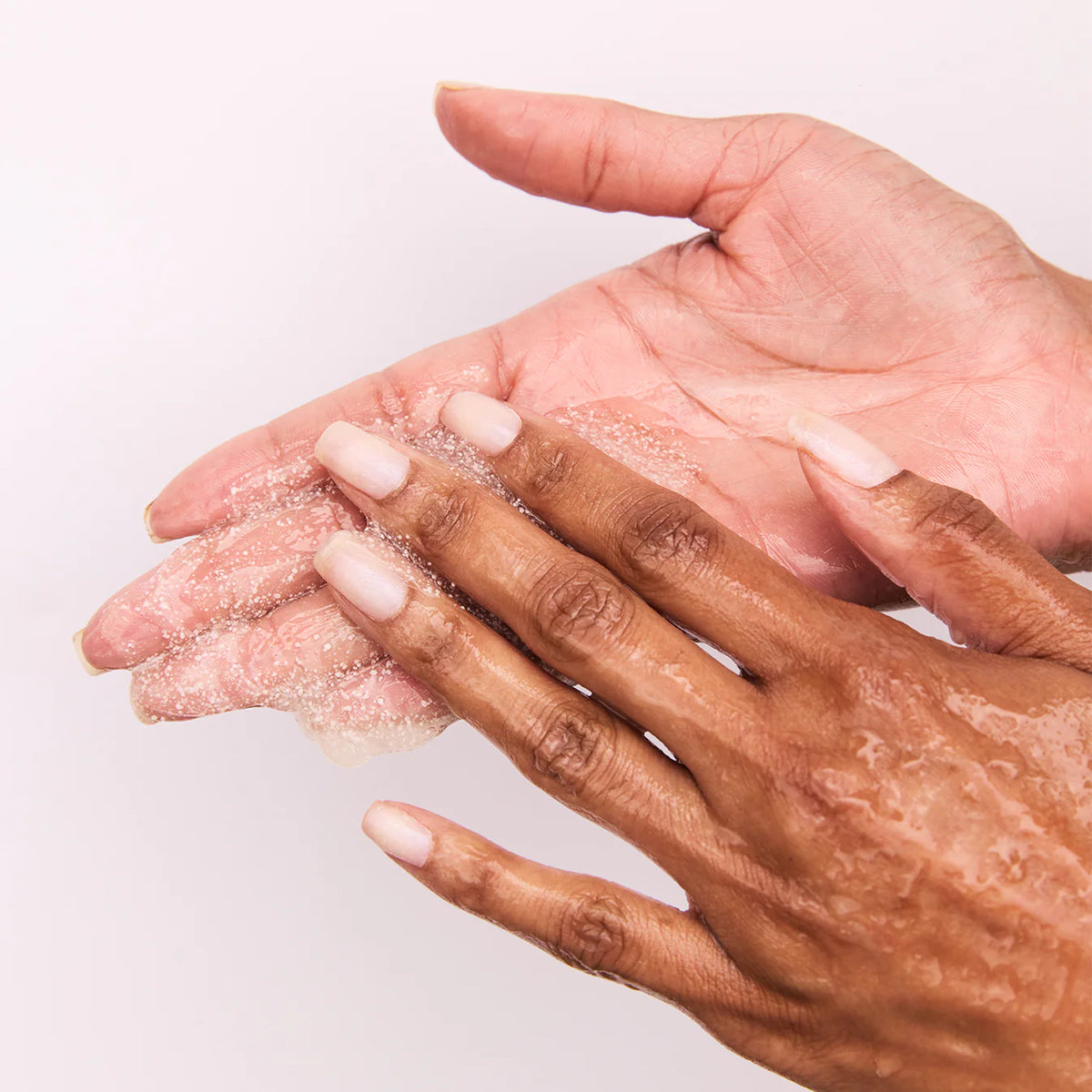 putting on hands Dermatologist-tested body exfoliator for sensitive skin