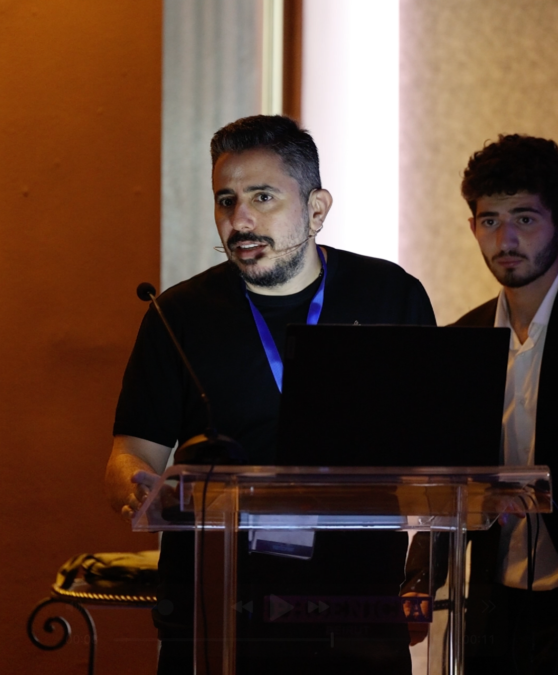 Dr. Rami Abadi standing at a podium Presenting