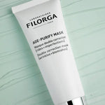 Filorga Age-Purify Mask tube on a light green textured background