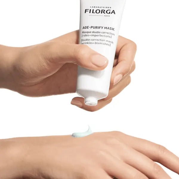 Hand holding a Filorga Filorga-AGE-PURIFY-MASK