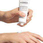 Hand holding a Filorga Filorga-AGE-PURIFY-MASK