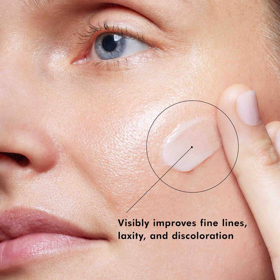 Close-up of a person applying a skincare product to their face with text indicating improvement of fine lines, laxity, and discoloration.
