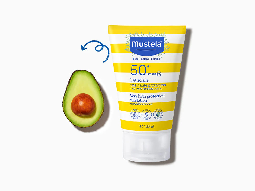 Mustela sunscreen tube with avocado on a white background