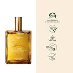 Gold bottle of Furterer hair oil with brand name and product details on a beige background