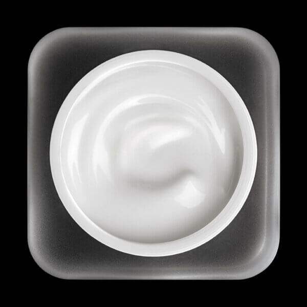 White cream in a square container on a black background