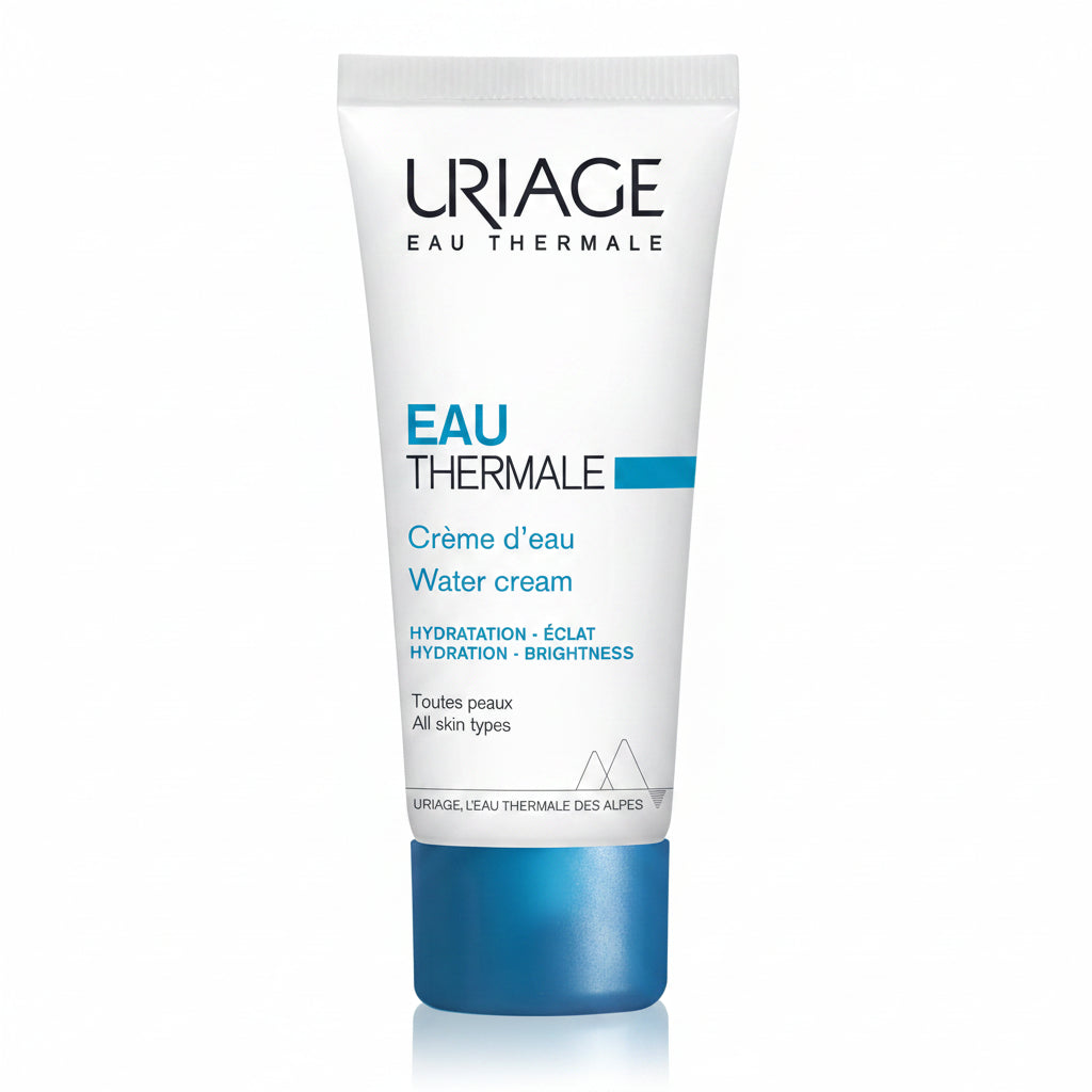 A white squeeze tube of Uriage Eau Thermale Water cream with a metallic blue cap, shown on a clean white background with a soft reflection.